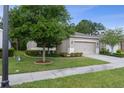 Charming single-Gathering home featuring a well-maintained lawn, mature trees, and neutral exterior paint at 17843 Garsalaso Cir, Brooksville, FL 34604