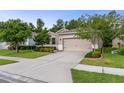Charming single-Gathering home featuring a well-maintained lawn, mature trees, and neutral exterior paint at 17843 Garsalaso Cir, Brooksville, FL 34604