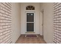 Inviting entryway featuring a decorative front door and tile flooring leading into the home at 2165 Springmeadow Dr, Spring Hill, FL 34606
