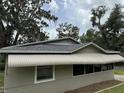 Side view showcasing the awning, windows, and roofline of this quaint home at 221 Highland St, Brooksville, FL 34601
