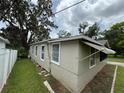 Angle view of the home with a view of windows and the surrounding yard at 221 Highland St, Brooksville, FL 34601
