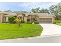 Charming single-story home with a well-manicured lawn and a screened garage in a serene neighborhood at 2481 Whispering Pines Ct, Spring Hill, FL 34606