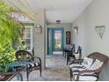 Inviting front porch with seating, decorative accents, and a stylish blue front door at 2486 Deer Trail Ln, Spring Hill, FL 34606