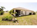 Spacious backyard features a screened lanai, verdant lawn, and mature landscaping at 2542 Sandy Hill Ct, Holiday, FL 34691
