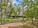 Two-story home set amongst large shade trees with verdant lawn and greenery at 27091 Country Oak Dr, Brooksville, FL 34602