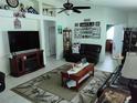 Comfortable living room with tile floors, fan and cozy furniture arrangement at 2930 Plantain Dr, Holiday, FL 34691