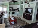 Bright living room open to the kitchen with modern decor and ceiling fan at 2930 Plantain Dr, Holiday, FL 34691