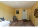 Inviting outdoor patio area with seating and tiled flooring offers a relaxing space at 3140 Bahia Ave, Holiday, FL 34690