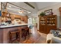 Charming kitchen with wooden cabinetry, a breakfast bar, and tile flooring at 3270 Endsley Rd, Brooksville, FL 34604