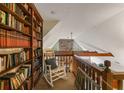 Library nook overlooking the living room, complete with a rocking chair and built-in bookshelf at 3270 Endsley Rd, Brooksville, FL 34604