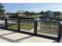 Picturesque view of a tranquil backyard with a canal, dock, and lush greenery from the private patio at 4104 Pine Dale Ct, Hernando Beach, FL 34607