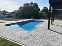 Relaxing backyard featuring a private pool, brick patio, and plenty of space for entertaining guests at 4104 Pine Dale Ct, Hernando Beach, FL 34607