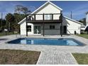 Beautiful backyard featuring a private in-ground pool, patio area, and a covered deck perfect for outdoor enjoyment at 4104 Pine Dale Ct, Hernando Beach, FL 34607