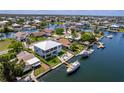 Aerial view showcases a waterfront property with boat dock, lush lawn, and outdoor seating for relaxed waterfront living at 4469 Bahama Dr, Hernando Beach, FL 34607