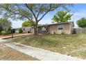 A charming single-story home with a well-kept lawn and mature trees, showcasing curb appeal and a welcoming facade at 4537 Cynthia Ln, Spring Hill, FL 34606