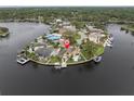 Aerial view of waterfront property with a pool, dock, and lush landscaping on the water at 5440 Manatee Point Drive, New Port Richey, FL 34652