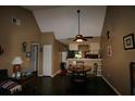 Dining room features wood floors, neutral paint, and views into the kitchen at 6338 Spring Flower Dr # 21, New Port Richey, FL 34653