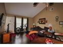 Living room with vaulted ceiling, wood floors, and entry door at 6338 Spring Flower Dr # 21, New Port Richey, FL 34653