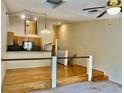 Living room with hardwood floors, open layout, and modern lighting at 6462 92Nd N Pl # 806, Pinellas Park, FL 33782