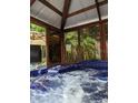 In-ground covered hot tub is perfect for relaxing and enjoying nature views at 6505 Broadwing Ct, Tampa, FL 33625