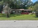 Charming single-story home with a covered carport and well-maintained front lawn at 717 Whiteway Dr, Brooksville, FL 34601