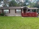 Charming single-story home with a covered carport and well-maintained front lawn at 717 Whiteway Dr, Brooksville, FL 34601