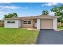 Charming single-story home featuring a well-maintained lawn and inviting curb appeal on a sunny day at 7316 Tangelo Ave, Port Richey, FL 34668