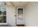 Front door has white trim and a 