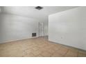 Bright living room featuring tile flooring, neutral walls, and natural light from the window at 8053 Dedham Dr, Port Richey, FL 34668