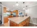 Spacious kitchen featuring an island with granite countertop, wood cabinets, and stainless steel appliances at 8213 Valley Stream Ln, Hudson, FL 34667