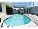 A sparkling swimming pool enclosed with a screened lanai for year-round enjoyment at 9003 Lido Ln, Port Richey, FL 34668