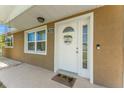 Close-up of the front entry highlighting a well-lit, inviting door with decorative wreath and house number at 9016 Unicorn Ave, Port Richey, FL 34668