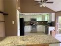 Cozy kitchen with white cabinetry, granite countertops, and stainless steel appliances at 9155 Pemberton St, Spring Hill, FL 34608