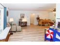 Bright living area with wood floors, comfortable seating, and windows that let in natural light at 9630 Eldridge Rd, Spring Hill, FL 34608