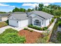 A beautiful aerial view of a well-manicured home with lush landscaping and a charming facade at 10935 New Brighton Ct, New Port Richey, FL 34654