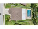 Aerial view of a home with an in-ground pool and fenced yard at 1104 Ketzal Dr, Trinity, FL 34655