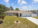 Lovely single-story home boasts an arched entryway, an attached garage, and a well-maintained lawn at 11280 Sedgefield Ave, Spring Hill, FL 34608