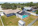 Aerial view of the home showcasing a screened-in pool and a convenient storage shed in the backyard at 11280 Sedgefield Ave, Spring Hill, FL 34608