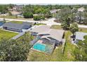 Aerial view featuring a screened-in pool and well-kept lawn, enhancing the home's outdoor appeal at 11280 Sedgefield Ave, Spring Hill, FL 34608