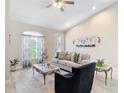 Inviting living room featuring a cozy sofa, elegant decor, and a large window providing ample natural light at 12323 House Finch, Weeki Wachee, FL 34614