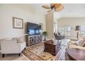Inviting living room with a ceiling fan, comfortable seating, and lots of natural light at 1242 Almondwood Dr, Trinity, FL 34655