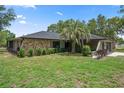 Inviting single-story home featuring a mix of stone and stucco exterior, complemented by a well-kept lawn at 1376 Fayetteville Dr, Spring Hill, FL 34609