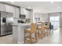 Bright, open kitchen with stainless steel appliances, breakfast bar, and seating for casual dining at 175 Voltaire Dr, Spring Hill, FL 34609