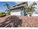 Attached two-car garage and brick driveway with room for multiple vehicles at 3150 Trident Ter, New Port Richey, FL 34652