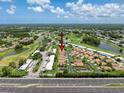 Scenic aerial view of a residential community featuring beautiful homes, lush greenery, and a serene lake at 3317 Abigail Ct, New Port Richey, FL 34655