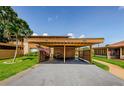 Assigned carport parking with well-manicured lawns on a sunny day at 3841 Lanyard Ct # B, New Port Richey, FL 34652
