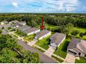 Aerial view of the property on a tree lined street, surrounded by well-maintained lawns at 4082 Watson Dr, New Port Richey, FL 34655