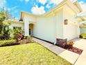 Inviting home exterior showcasing a well-maintained lawn, stone accents, and a welcoming front entrance at 4082 Watson Dr, New Port Richey, FL 34655