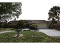 Charming single-story home featuring a well-manicured lawn, mature trees, and a two-car garage at 4269 River Birch Dr, Spring Hill, FL 34607