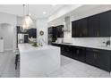 Stylish kitchen featuring a large center island, sleek cabinetry, and stainless steel appliances at 4287 Woodland Retreat Blvd, New Port Richey, FL 34655